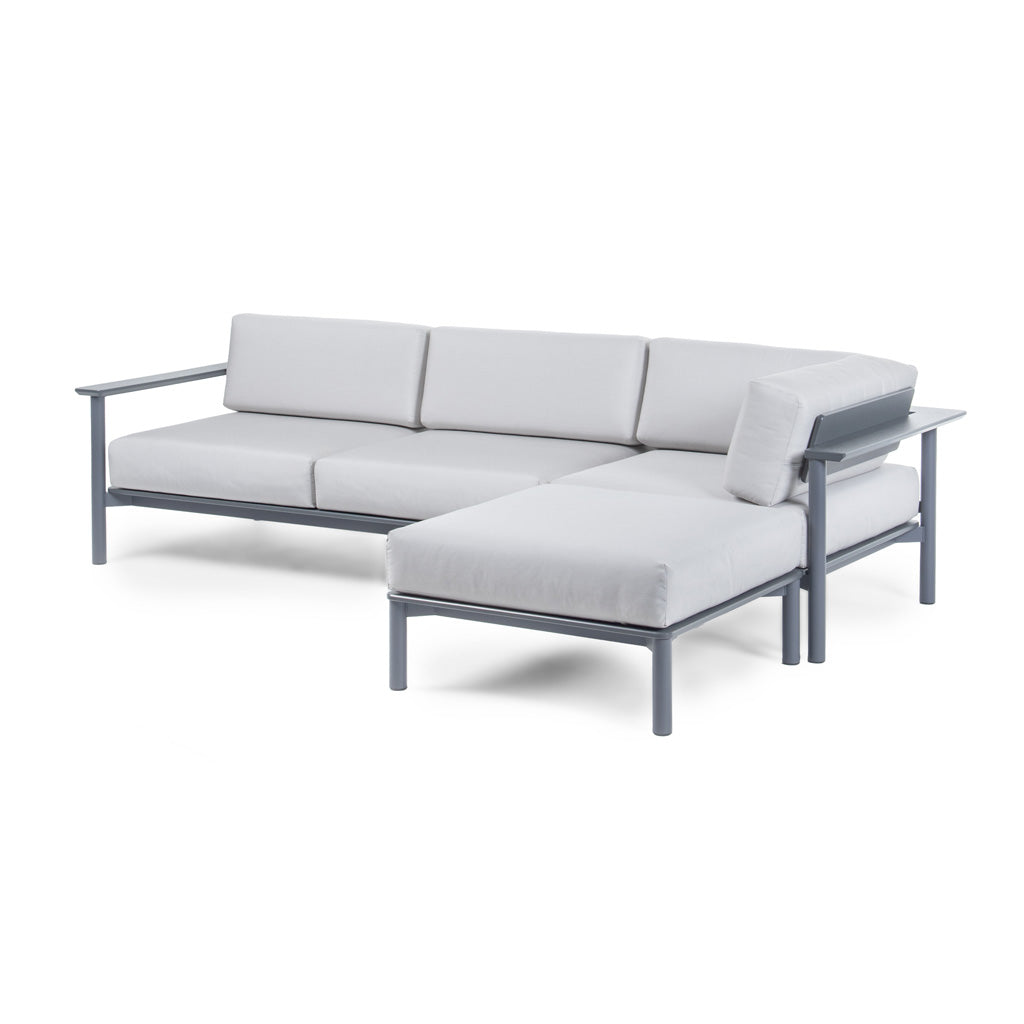 Aurora configuration set up in an "L" with a Right Arm Sofa, Corner Lounge, and Ottoman with Charcoal frame and Cloud cushions. 