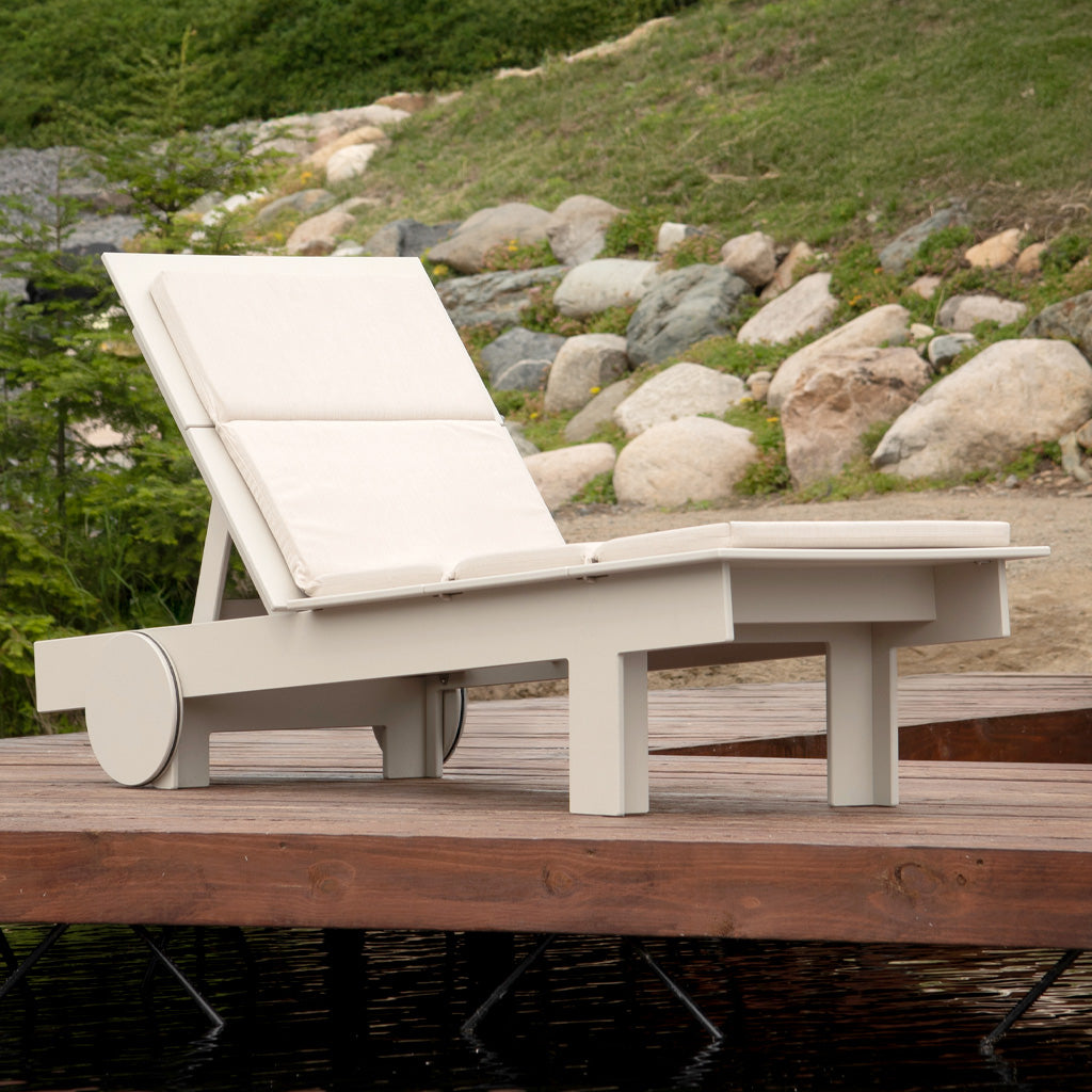 Image of a fog tall chaise with flax cushion on a dock